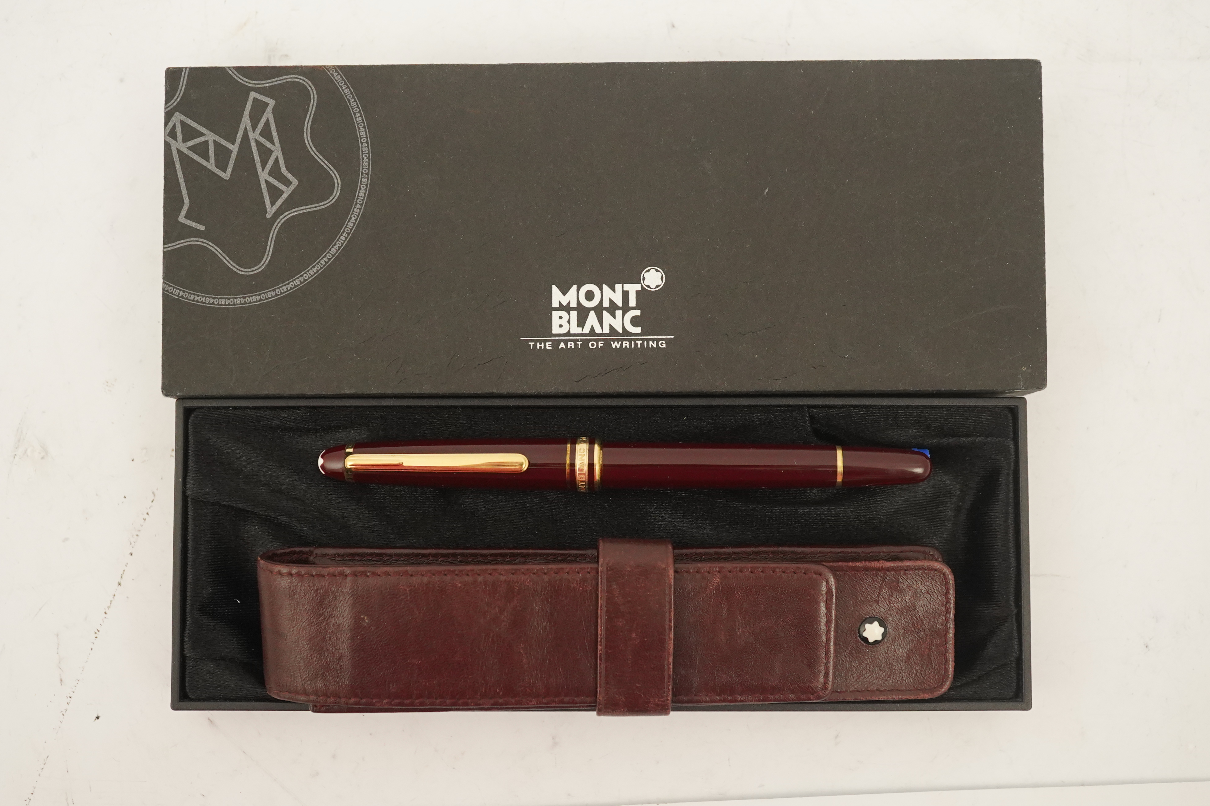 A Mont Blanc Meisterstuck maroon and gilt rollerball pen, boxed with paperwork and leather case